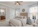 Bright bedroom features neutral walls and carpet, a large window, and a spacious closet at 8301 Caesars Head Dr, Waxhaw, NC 28173