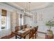 A bright dining room features an elegant chandelier, trim detail, and lots of natural light at 8301 Caesars Head Dr, Waxhaw, NC 28173