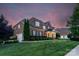 Brick home featuring a two-car garage, manicured landscaping, and well-maintained lawn at 8301 Caesars Head Dr, Waxhaw, NC 28173