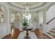 Inviting foyer with hardwood floors, decorative columns, and elegant lighting at 8301 Caesars Head Dr, Waxhaw, NC 28173
