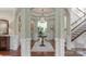Inviting foyer with hardwood floors, decorative columns, and elegant lighting at 8301 Caesars Head Dr, Waxhaw, NC 28173