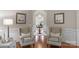 Elegant foyer features hardwood floors, detailed trim, and seating, creating an inviting entrance to the home at 8301 Caesars Head Dr, Waxhaw, NC 28173