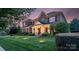 Charming two-story brick home featuring a welcoming front porch and manicured landscaping at 8301 Caesars Head Dr, Waxhaw, NC 28173