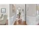 Elegant hallway with hardwood floors, wainscoting, and decorative accents at 8301 Caesars Head Dr, Waxhaw, NC 28173
