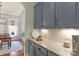 Kitchenette has granite countertops and gray cabinets near a dining room at 8301 Caesars Head Dr, Waxhaw, NC 28173