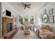 A cozy living room features a stone fireplace, large windows, and comfortable seating at 8301 Caesars Head Dr, Waxhaw, NC 28173