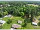 Expansive aerial view of a rural property featuring well-kept grounds and several detached buildings at 9135 Stokes Ferry Rd, Salisbury, NC 28146