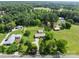 Stunning aerial view of a charming rural property with lush greenery and several buildings at 9135 Stokes Ferry Rd, Salisbury, NC 28146
