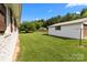 Exterior shot of a home's white brick facade, with a well-manicured lawn and detached garage at 9135 Stokes Ferry Rd, Salisbury, NC 28146