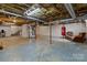 Unfinished basement offering flexible space for storage or customization, featuring exposed ceiling and white-painted walls at 9135 Stokes Ferry Rd, Salisbury, NC 28146