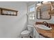Bathroom with toilet, sink and a unique wood countertop at 9135 Stokes Ferry Rd, Salisbury, NC 28146