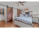 Bright bedroom boasts hardwood floors, barn doors, and direct access to the bathroom at 9135 Stokes Ferry Rd, Salisbury, NC 28146