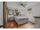 Cozy bedroom featuring hardwood floors, ceiling fan, barn doors, and two windows at 9135 Stokes Ferry Rd, Salisbury, NC 28146