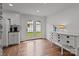 Bright dining area with French doors and hardwood floors adjacent to a white cabinet buffet at 9135 Stokes Ferry Rd, Salisbury, NC 28146