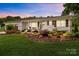 Charming brick home featuring a meticulously landscaped front yard and a welcoming front porch at 9135 Stokes Ferry Rd, Salisbury, NC 28146