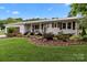 Charming brick home featuring a meticulously landscaped front yard and a welcoming front porch at 9135 Stokes Ferry Rd, Salisbury, NC 28146