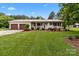 Beautiful home with a lush green lawn, a charming brick facade, and inviting curb appeal at 9135 Stokes Ferry Rd, Salisbury, NC 28146