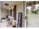 Inviting front porch featuring a cozy bench, brick accents, and a 'Welcome' sign at 9135 Stokes Ferry Rd, Salisbury, NC 28146