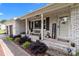 Charming front porch with a brick foundation, a cozy bench, and a 'Welcome' sign at 9135 Stokes Ferry Rd, Salisbury, NC 28146