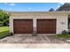 Attached two-car garage featuring wood doors and a well-maintained concrete driveway at 9135 Stokes Ferry Rd, Salisbury, NC 28146
