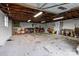 Spacious garage interior with exposed wood beams, concrete floor, and ample storage space at 9135 Stokes Ferry Rd, Salisbury, NC 28146
