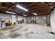 Inside a large, unfinished garage with a concrete floor, exposed beams, and white-painted walls at 9135 Stokes Ferry Rd, Salisbury, NC 28146