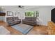 Bright living room featuring large windows and hardwood floors with a blue area rug at 9135 Stokes Ferry Rd, Salisbury, NC 28146