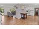 Open living space featuring a brick fireplace, hardwood floors, and natural light at 9135 Stokes Ferry Rd, Salisbury, NC 28146