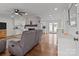 Bright living room featuring a brick fireplace, hardwood floors, and white trim details at 9135 Stokes Ferry Rd, Salisbury, NC 28146
