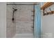 Modern shower features light tile, shower head and shower curtain at 9135 Stokes Ferry Rd, Salisbury, NC 28146