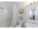 Bright bathroom with a shower-tub combination, vanity, and decorative wall shelves at 9216 Four Mile Creek Rd, Charlotte, NC 28277