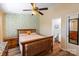 Cozy bedroom with decorative wallpaper, a ceiling fan, and a connecting bathroom at 9216 Four Mile Creek Rd, Charlotte, NC 28277