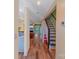 Inviting entryway featuring hardwood floors, staircase, and view into the living room at 9216 Four Mile Creek Rd, Charlotte, NC 28277