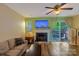 Inviting living room featuring a fireplace, a ceiling fan, and a sliding glass door at 9216 Four Mile Creek Rd, Charlotte, NC 28277