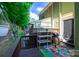 Relaxing patio area with a grill, outdoor seating, and a view of the lush surroundings at 9216 Four Mile Creek Rd, Charlotte, NC 28277