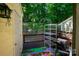 Private patio area with grilling space, shelving, and an adjacent storage unit at 9216 Four Mile Creek Rd, Charlotte, NC 28277