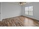 Bedroom with natural light, a ceiling fan, and wood-look flooring at 10207 Garmoyle St, Charlotte, NC 28277