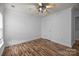 Empty bedroom showcasing wood-look floors and a ceiling fan at 10207 Garmoyle St, Charlotte, NC 28277