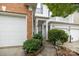 Charming home entrance with a blue front door, manicured bushes, and well-lit walkway at 10207 Garmoyle St, Charlotte, NC 28277