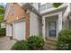 Inviting entrance with blue door, well-maintained landscaping, and a charming, covered porch at 10207 Garmoyle St, Charlotte, NC 28277
