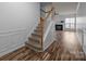 Entryway with staircase and wood floors leading to a living area with fireplace at 10207 Garmoyle St, Charlotte, NC 28277