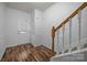 Hallway with staircase and paneled walls, leading to the front door at 10207 Garmoyle St, Charlotte, NC 28277