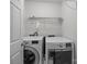 This laundry room has a side-by-side washer and dryer and wire shelving above at 10207 Garmoyle St, Charlotte, NC 28277