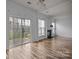 Bright living room with hardwood floors, a fireplace, and sliding glass doors at 10207 Garmoyle St, Charlotte, NC 28277