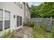 A small patio area with a sliding glass door and fenced-in yard at 10207 Garmoyle St, Charlotte, NC 28277