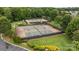 Aerial view of the well-maintained community tennis courts surrounded by lush green landscaping at 10207 Garmoyle St, Charlotte, NC 28277