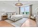 Serene main bedroom featuring natural light, tray ceilings, and hardwood floors at 1022 Paddlers Way # 136, Belmont, NC 28012