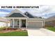 Charming single-Gathering home with a manicured lawn, a welcoming porch, and an attached two-car garage at 104 Noah Ln, Troutman, NC 28166