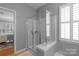 Bathroom featuring a glass-enclosed shower and abundant natural light through a large window with plantation shutters at 10405 Scotland Ave, Indian Land, SC 29707