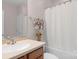 Bathroom with a single vanity, a large mirror, wood cabinets and a tub and shower combination with curtains at 10405 Scotland Ave, Indian Land, SC 29707